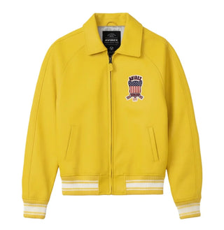 Front view of Avirex men’s yellow leather varsity bomber with chest shield patch, front zip and striped rib-knit trims