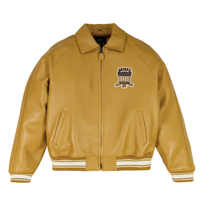 Front view of Avirex x Timberland men’s tan leather varsity bomber with chest patch, zip front and striped rib trims