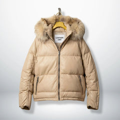 Front view of beige leather puffer jacket with real fur hood and zip pockets.