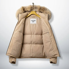 Inside view of beige leather puffer jacket with padded lining and inner zip pocket.