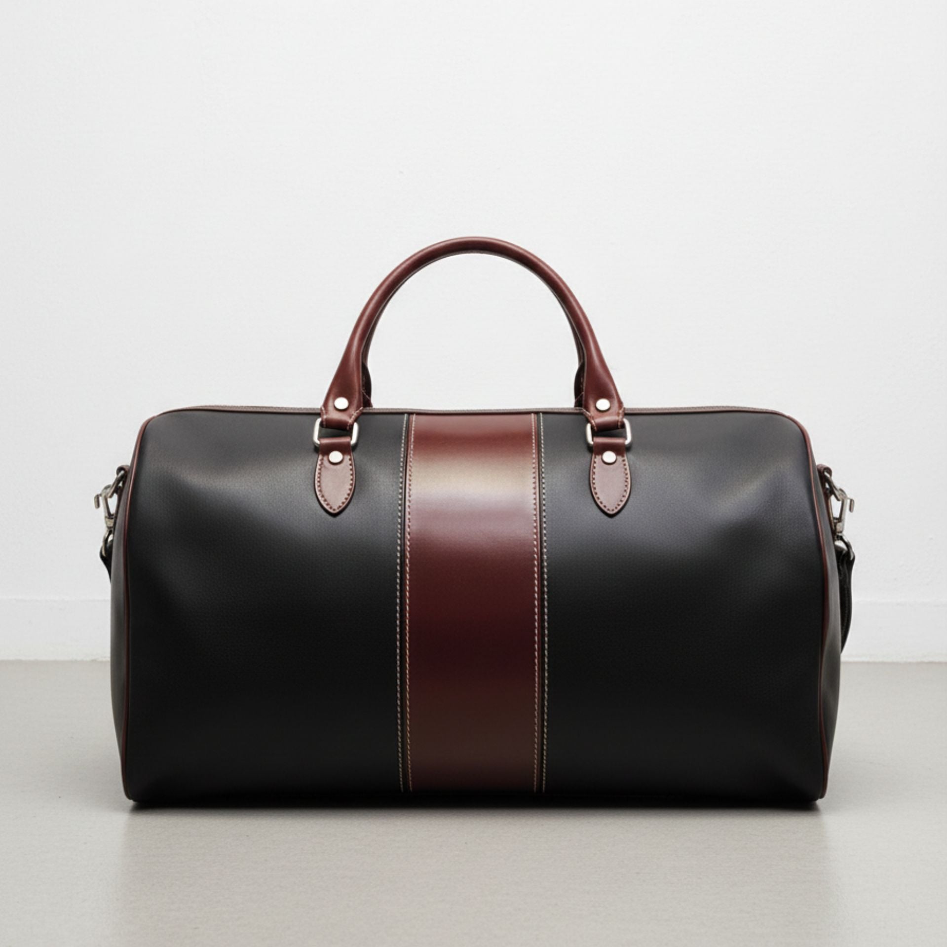 black leather duffle bag with brown center stripe and double handles.