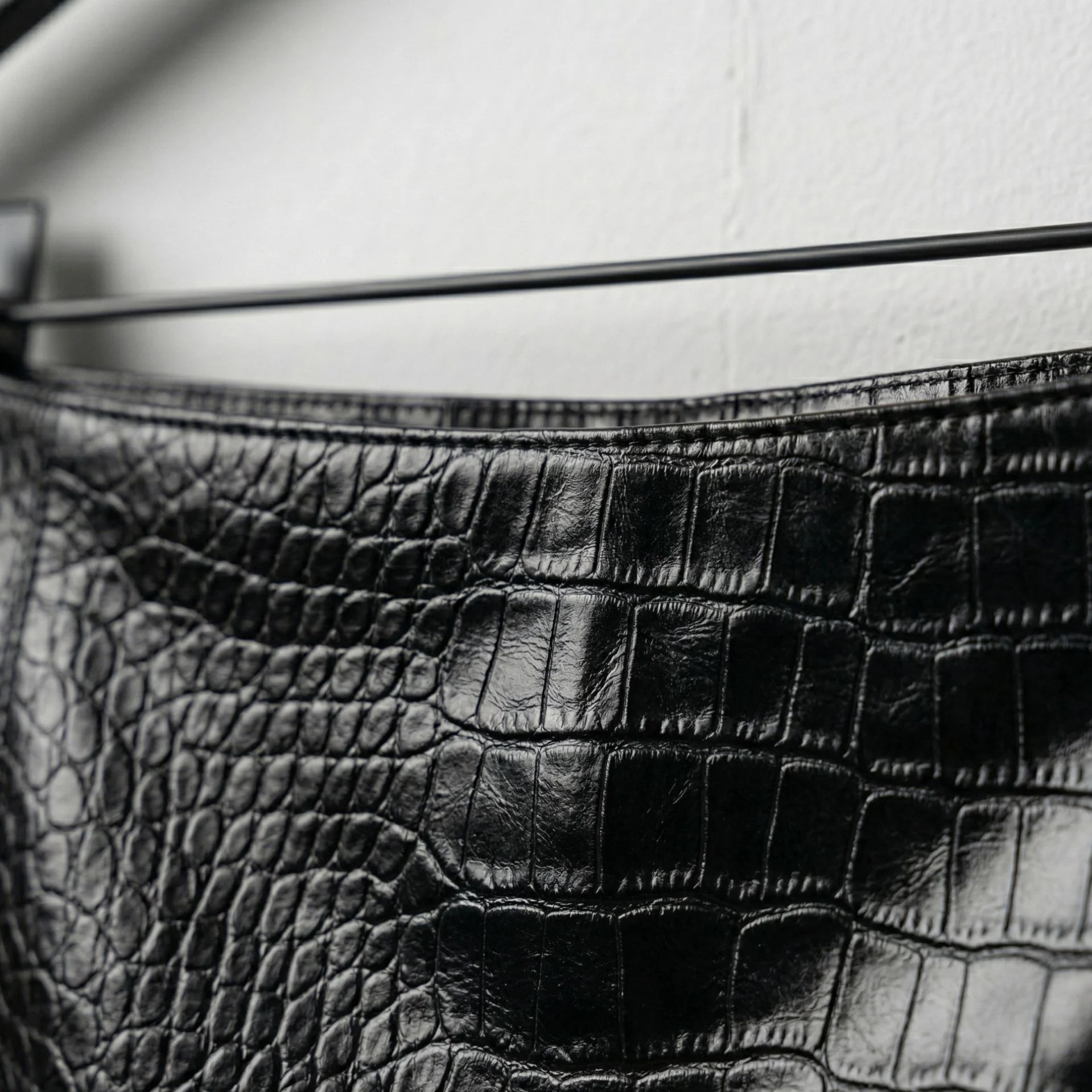 Close up of croc embossed pattern on black genuine leather skirt