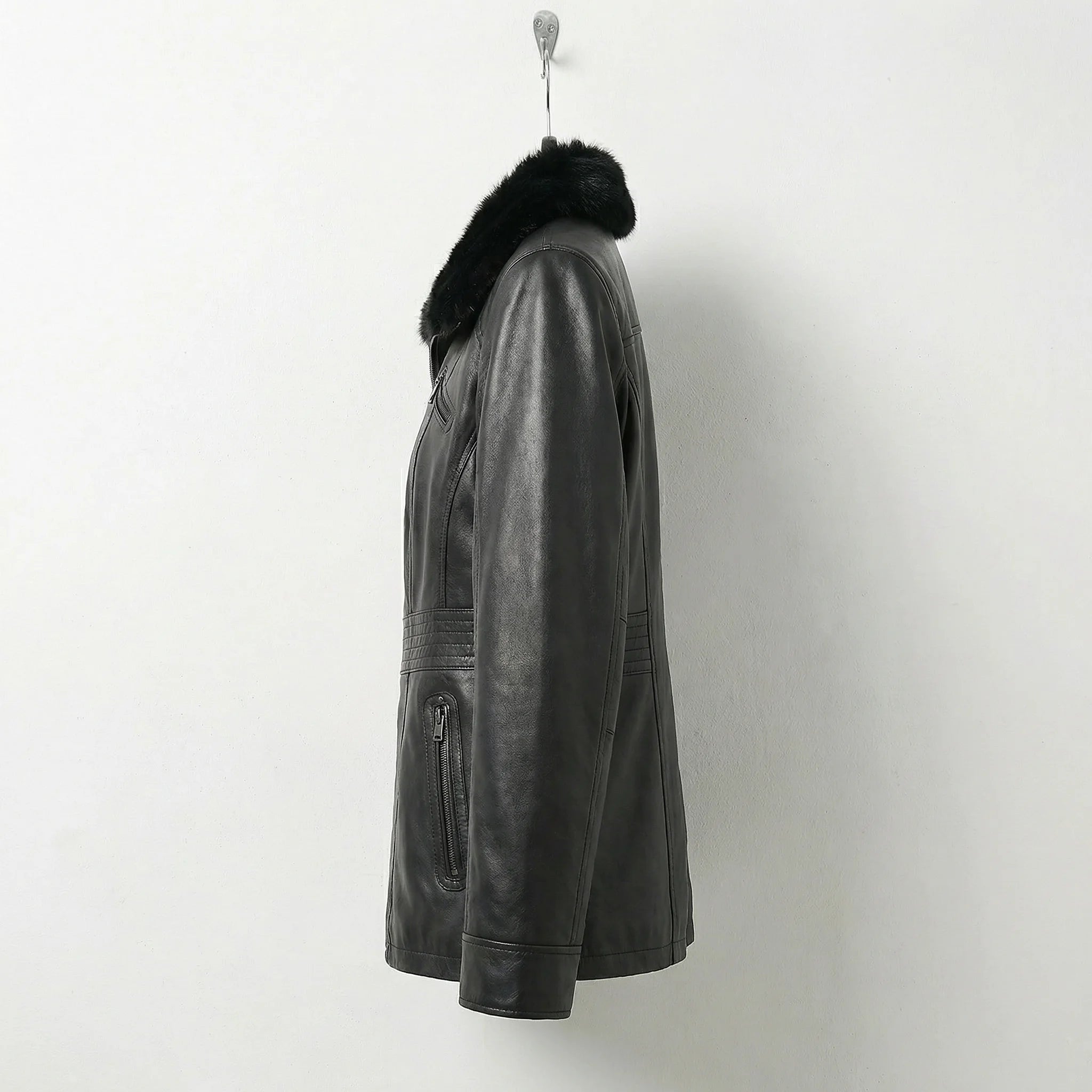 Side view of womens fitted black fur collar leather jacket
