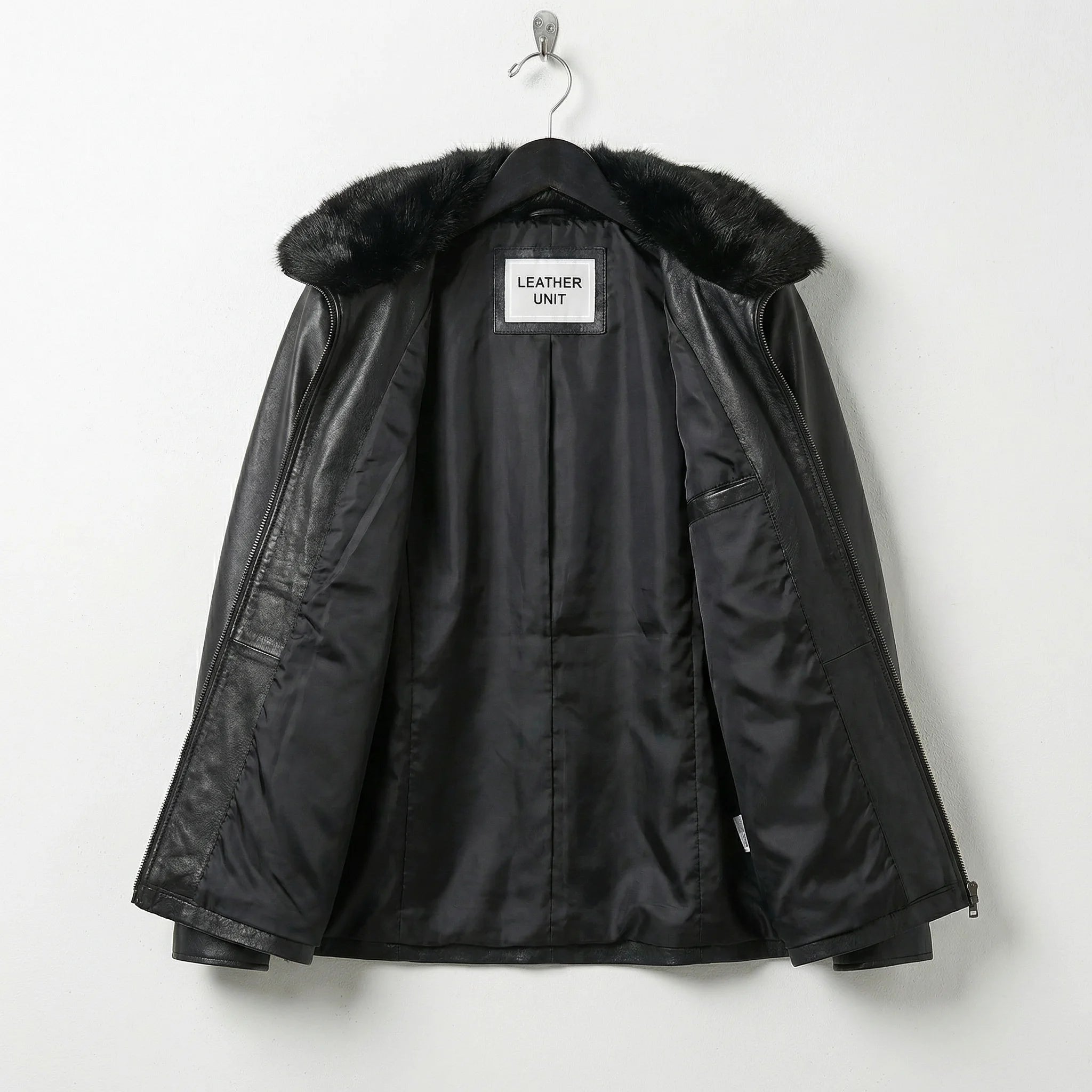 Interior lining of womens black leather jacket showing inner construction