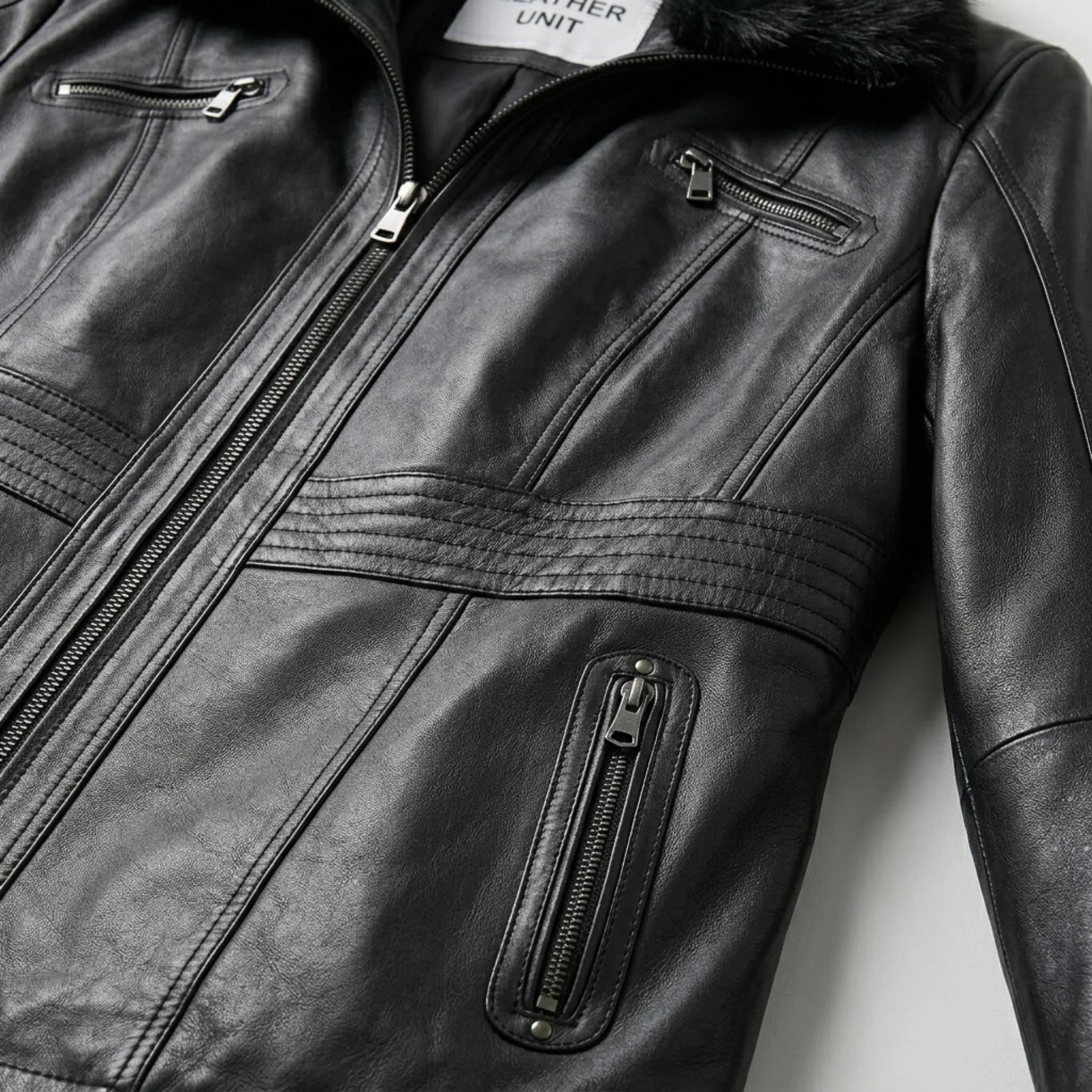 Zipper and pocket detail on womens black fur collar leather jacket