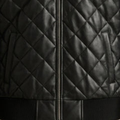 Close-up of functional pockets and heavy-duty zipper on black hooded leather bomber jacket
