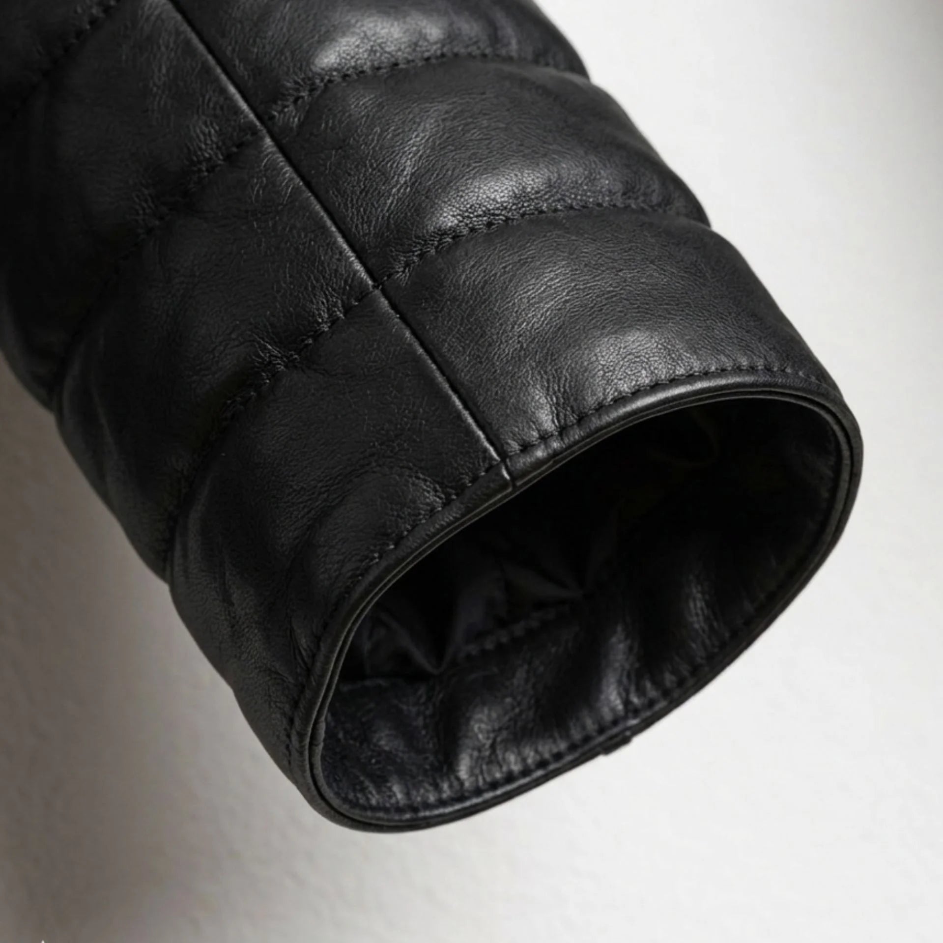 Detailed view of sleeve and cuff on genuine sheepskin hooded puffer jacket