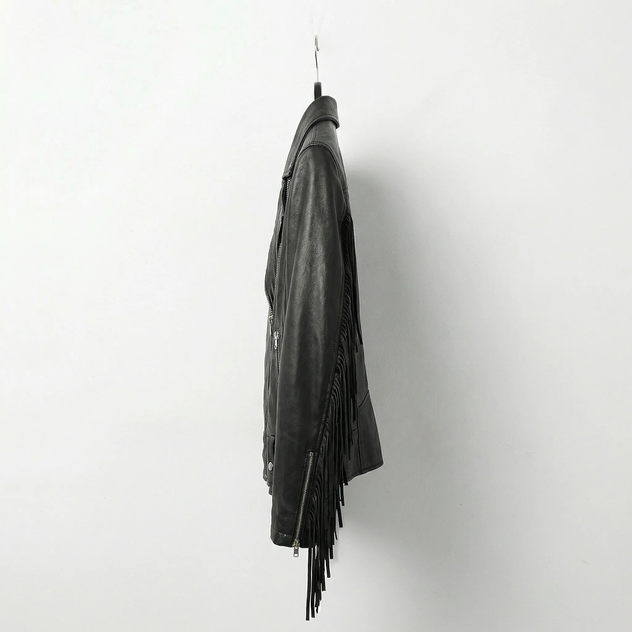 Side view of womens black fringe biker leather jacket showing flowing fringe