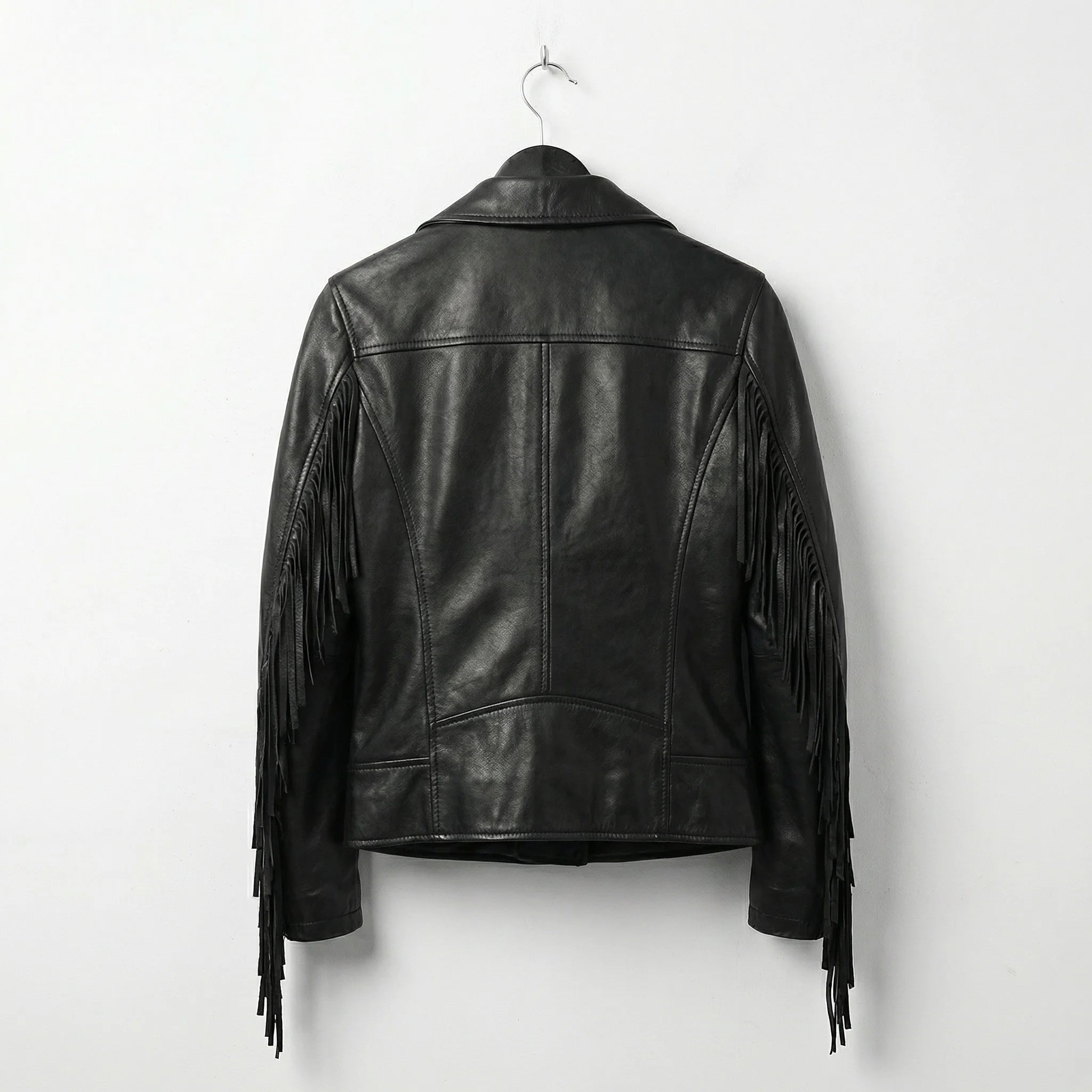 Back view of womens black leather jacket with fringe on sleeves