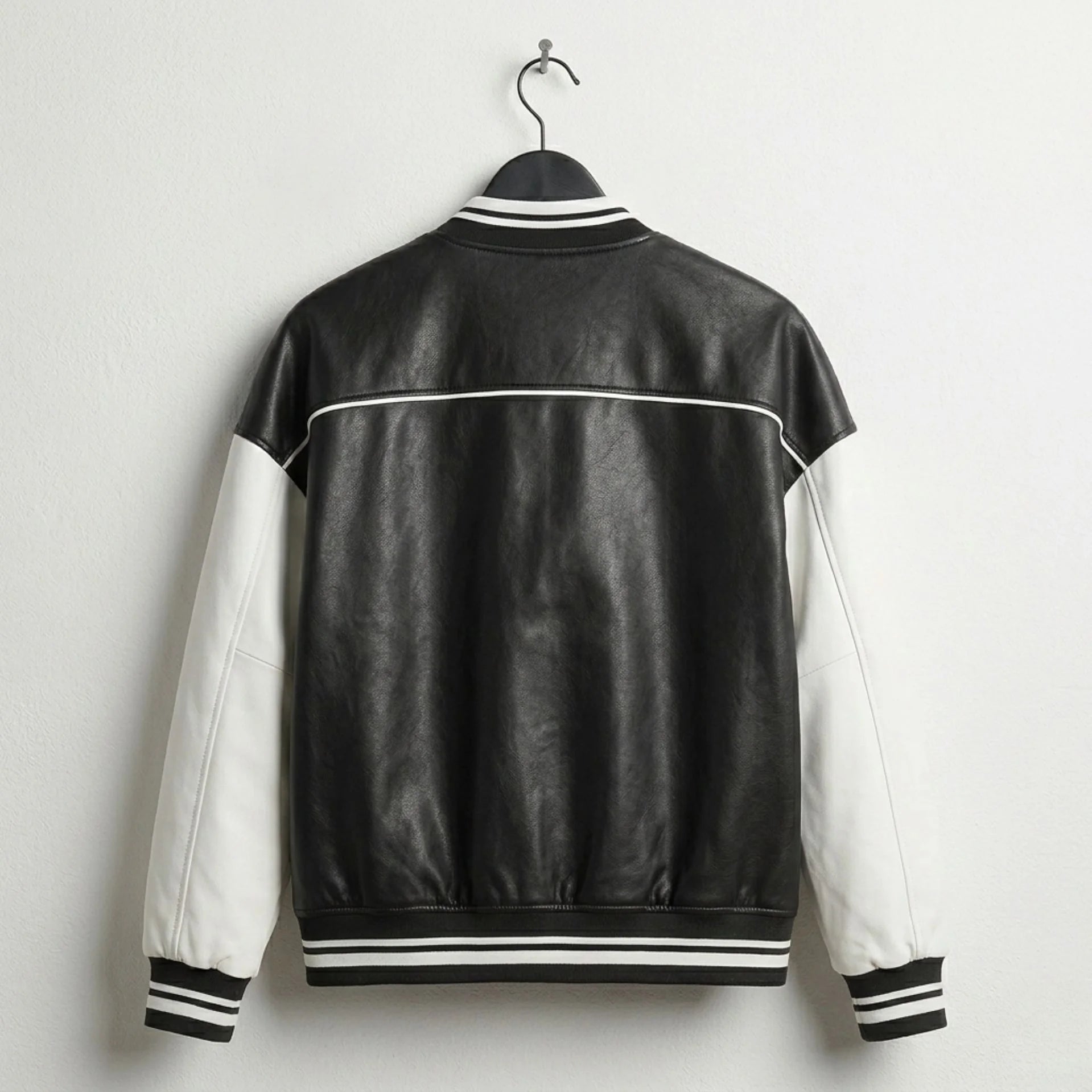 Back view of womens black and white leather varsity jacket