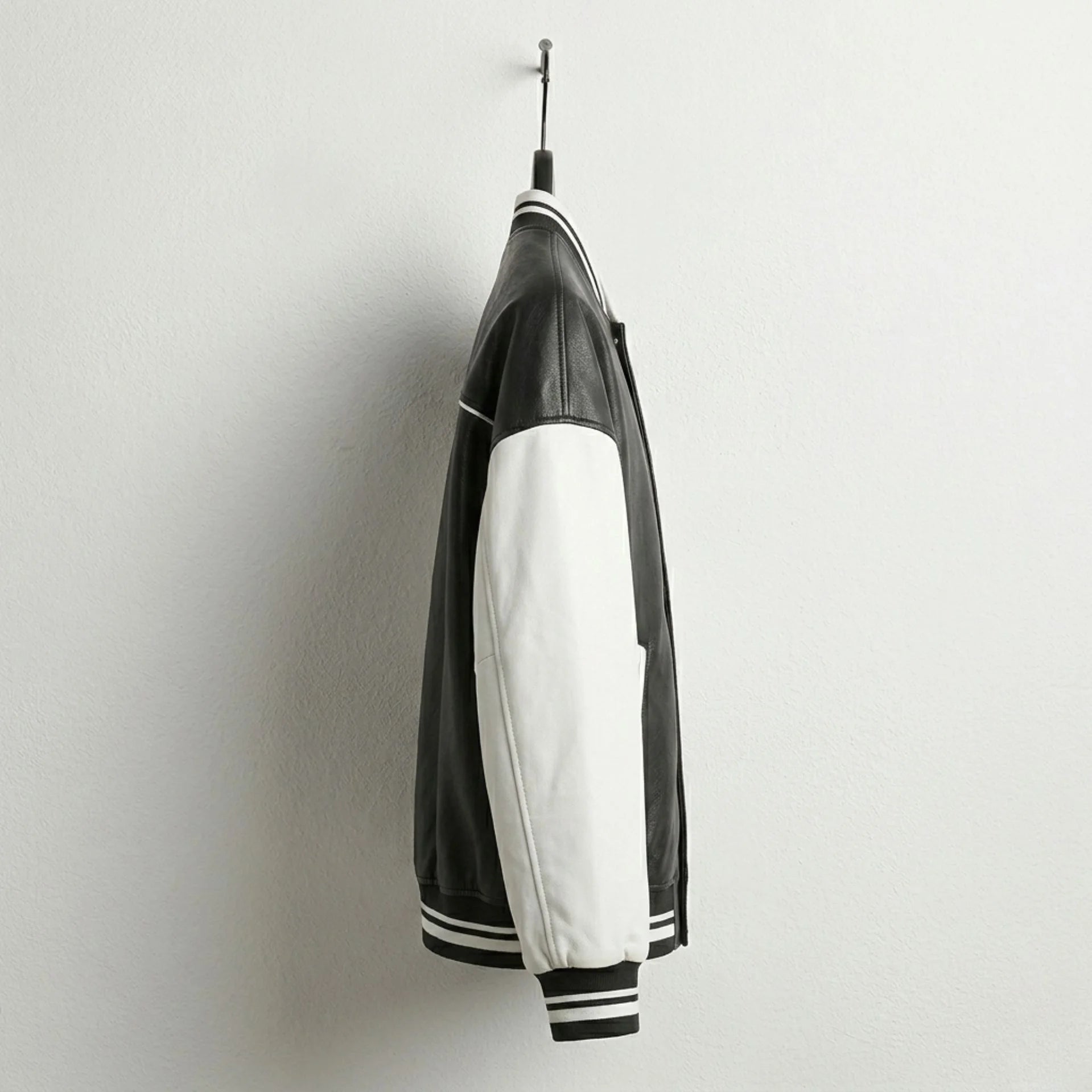 Side view of black and white baseball varsity leather jacket