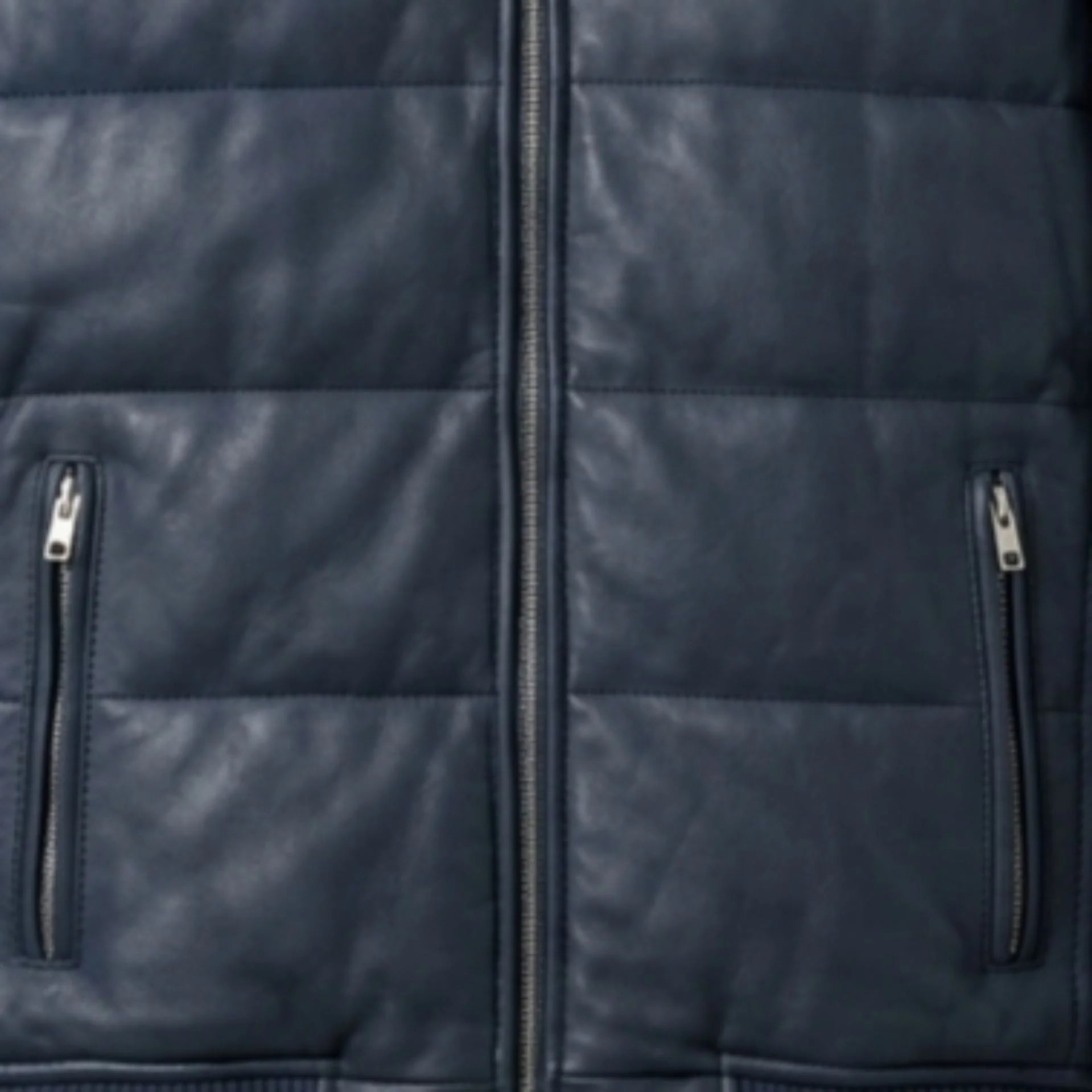 Close-up of vertical zip pockets on blue leather puffer bomber jacket
