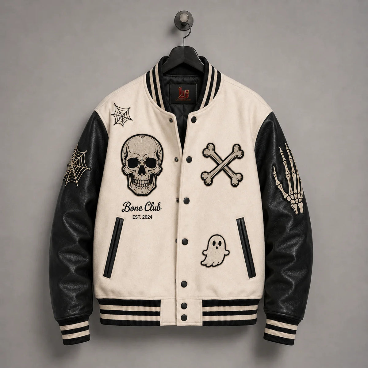 Front hanger view of Bone Club Halloween jacket with skull, crossbones, ghost, spider-web and skeleton-hand embroidery