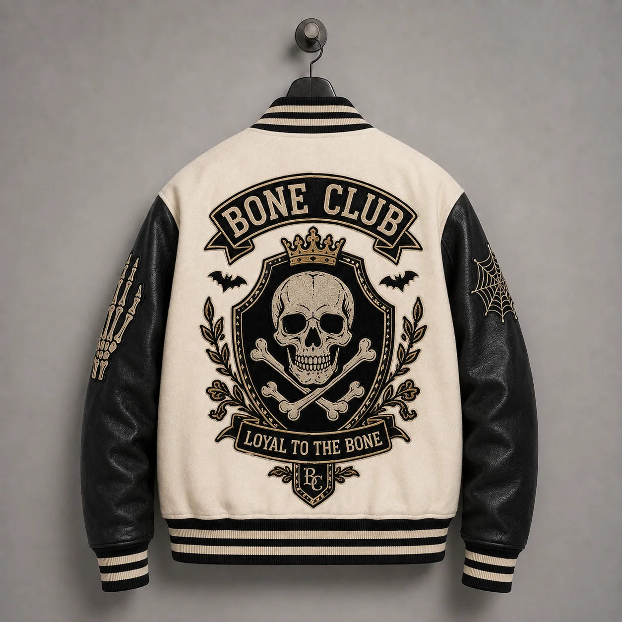 Back hanger view of Bone Club skull varsity jacket featuring crowned skull-and-crossbones crest and bat embroidery