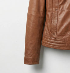 Close up of brown leather bomber jacket sleeve and quilted hem detail