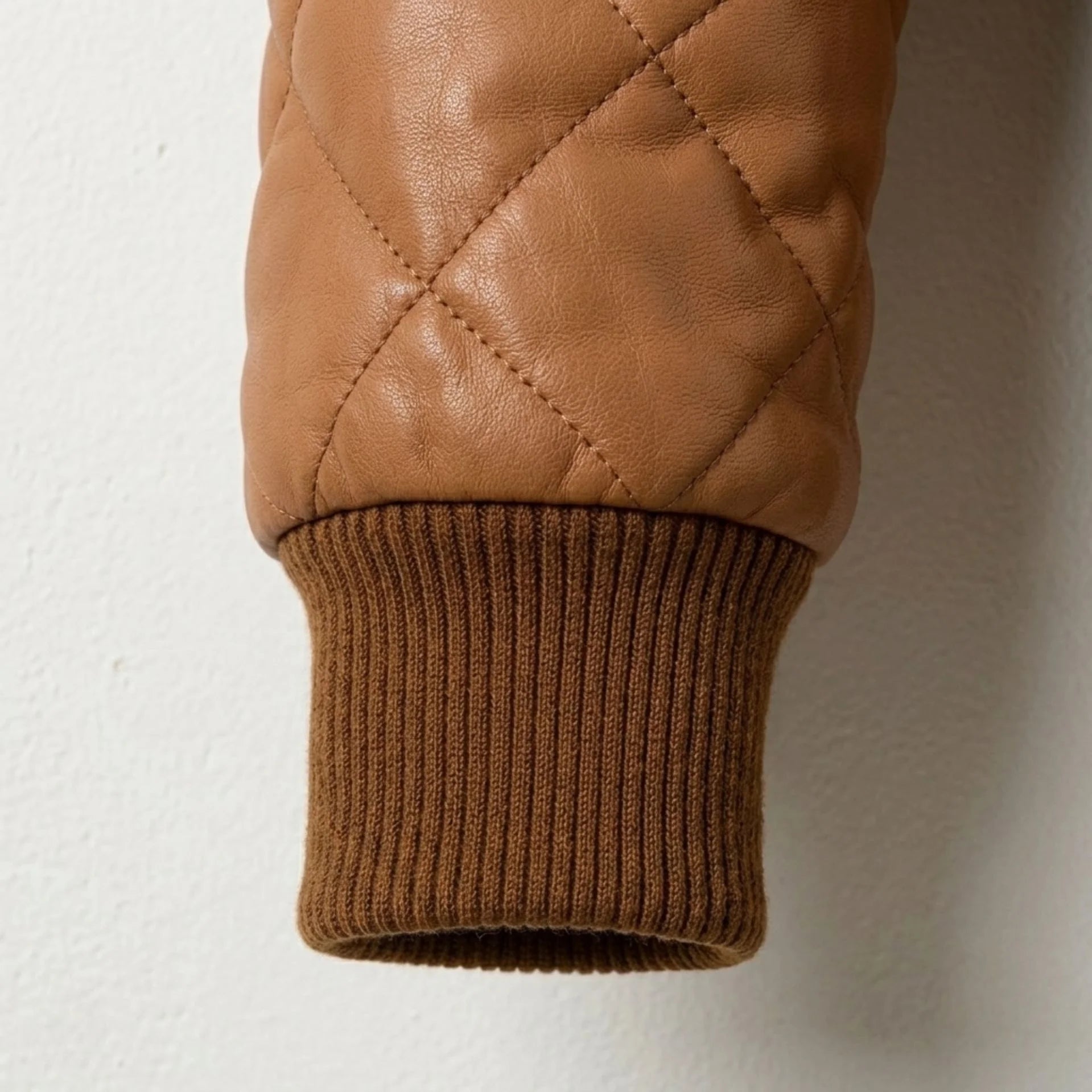 Detailed view of ribbed cuff and premium quilted leather texture