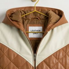 Close-up of attached hood and contrast panels on brown leather puffer bomber jacket