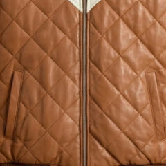 Close-up of functional pockets and heavy-duty zipper on brown hooded leather bomber jacket