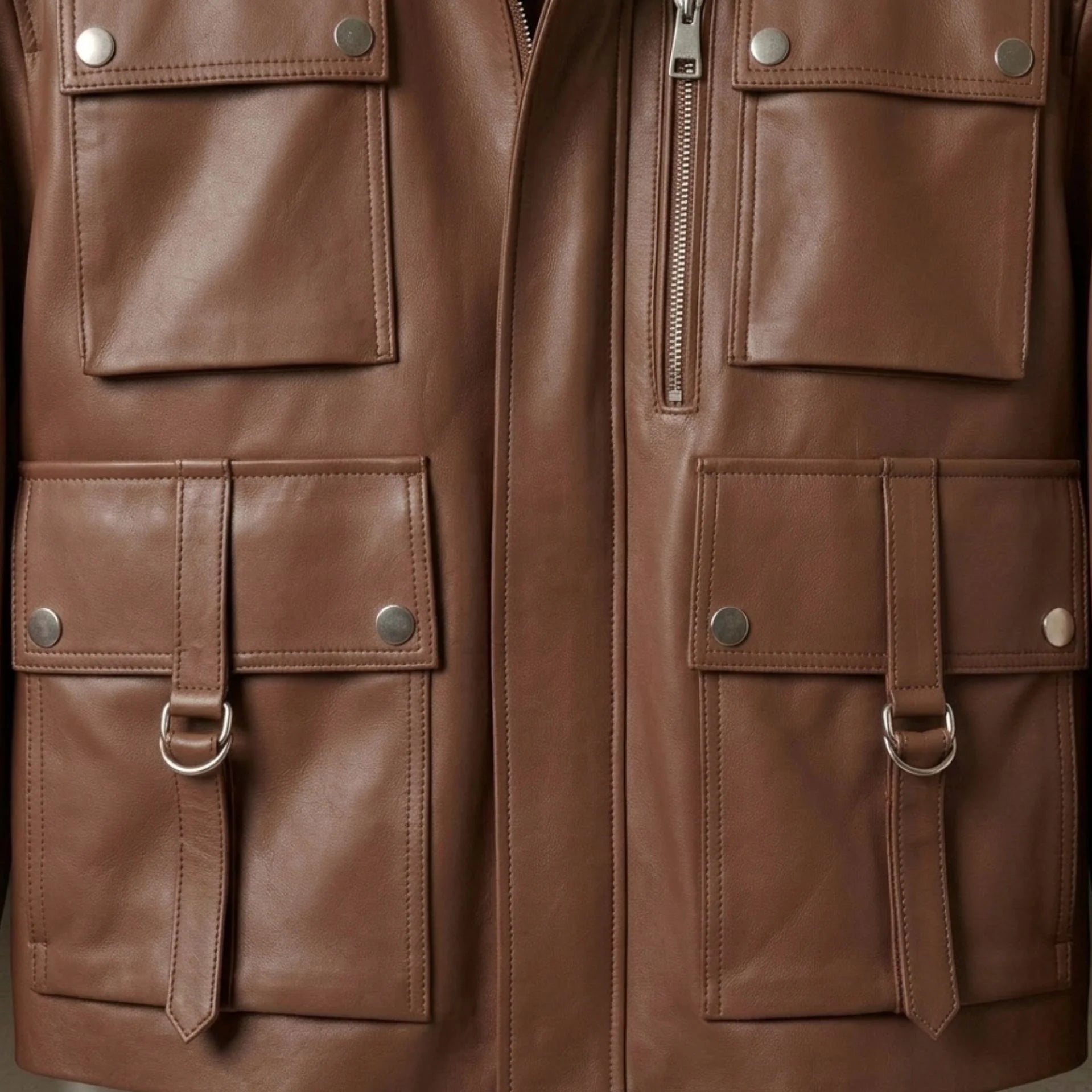 Front flap pockets and D ring straps on womens brown utility leather jacket