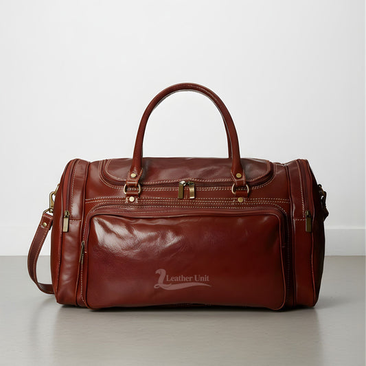 front view brown genuine leather duffle bag with three exterior pockets.
