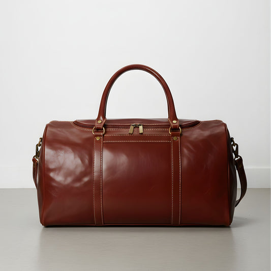 brown leather duffle bag with detachable shoulder strap and double handles.