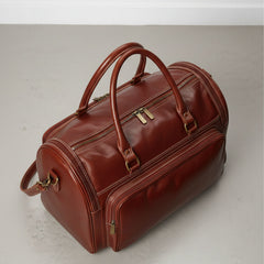 top view brown leather duffle bag with full length zip closure.