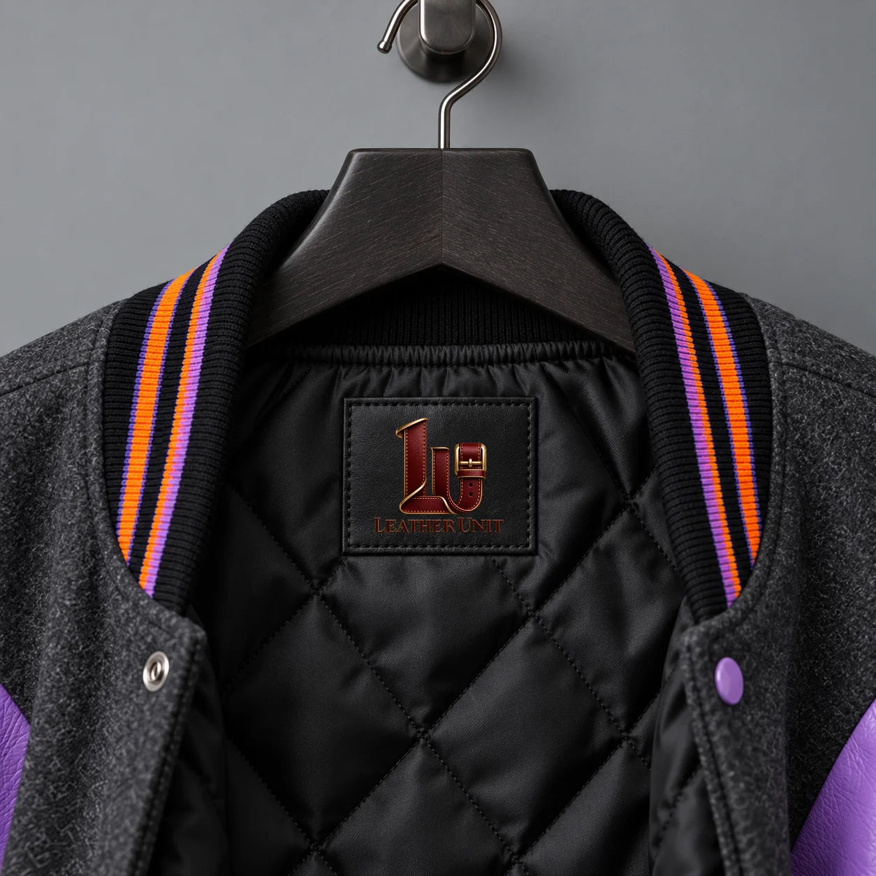 Close-up of Candy Curse neck label, black diamond-quilted lining and striped orange-purple varsity collar