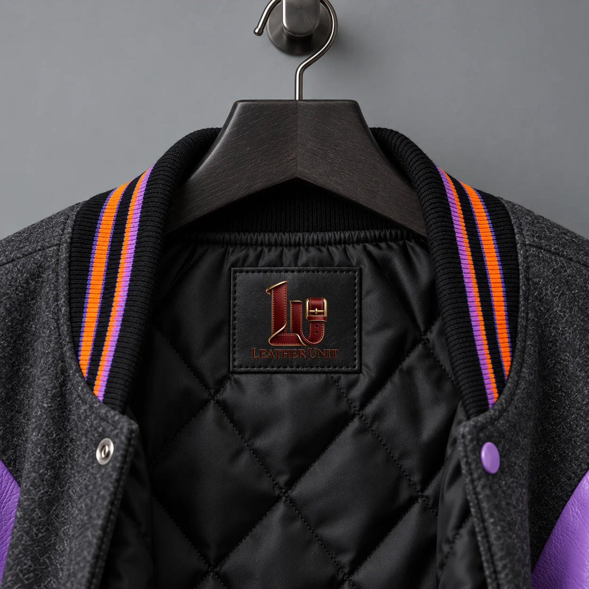 Close-up of Candy Curse neck label, black diamond-quilted lining and striped orange-purple varsity collar