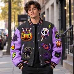 Model wearing charcoal Candy Curse Halloween varsity jacket with lavender sleeves and colourful candy patches outdoors