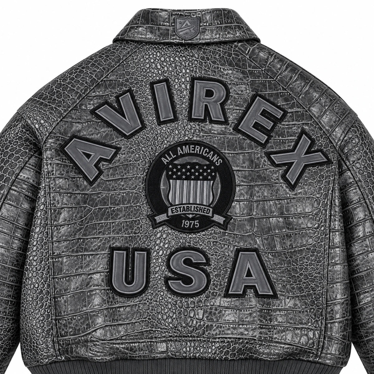 Close-up of grey crocodile-textured leather jacket back showing raised USA lettering and central shield emblem