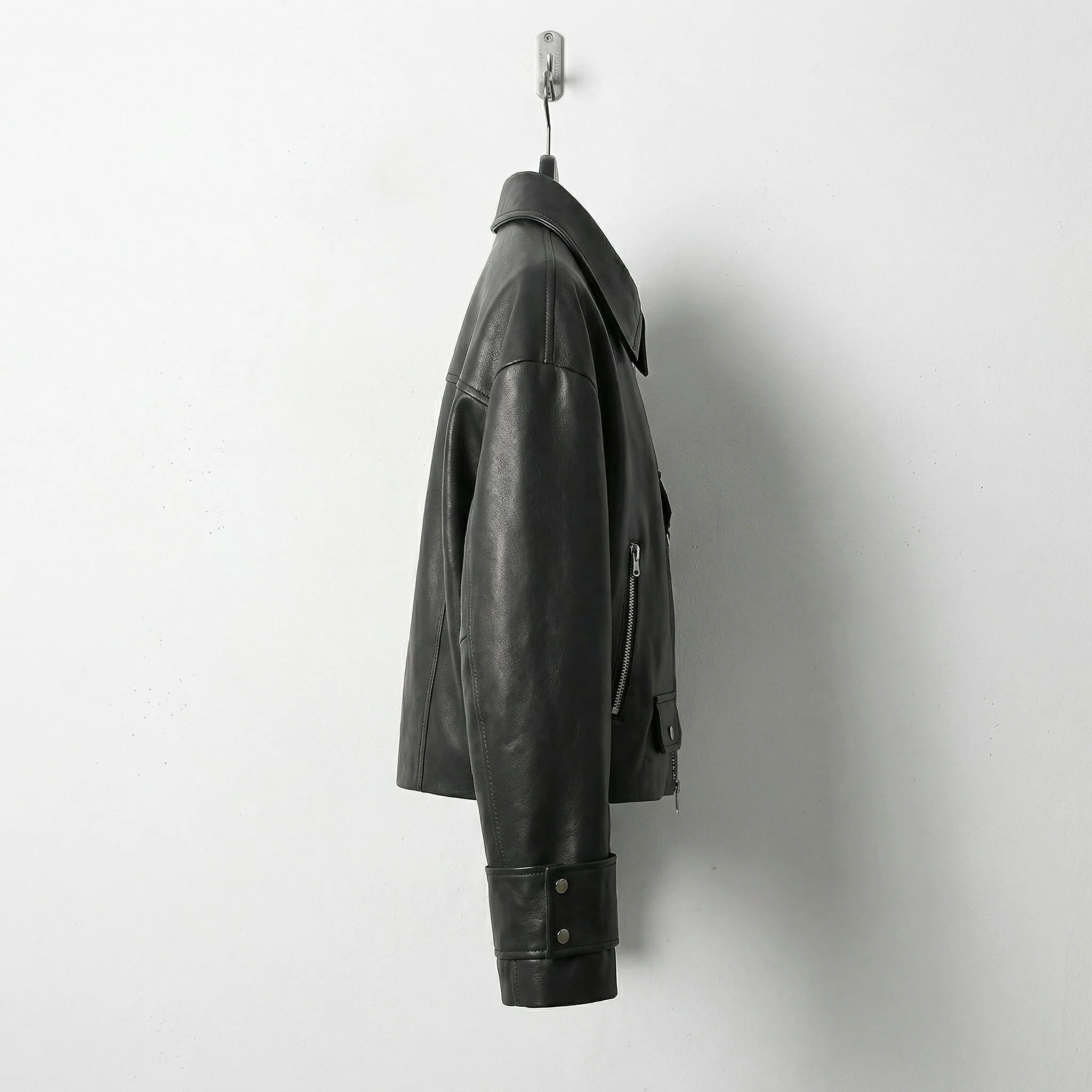 Side profile of womens black leather jacket with cuff straps