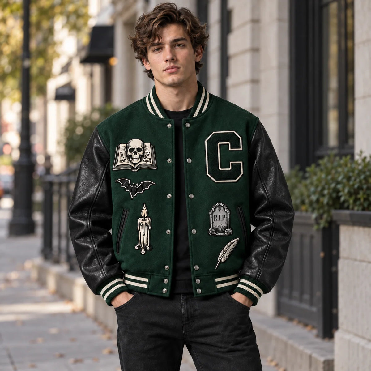 Model wearing forest green Crypt Academy gothic Halloween varsity jacket with black leather sleeves outdoors