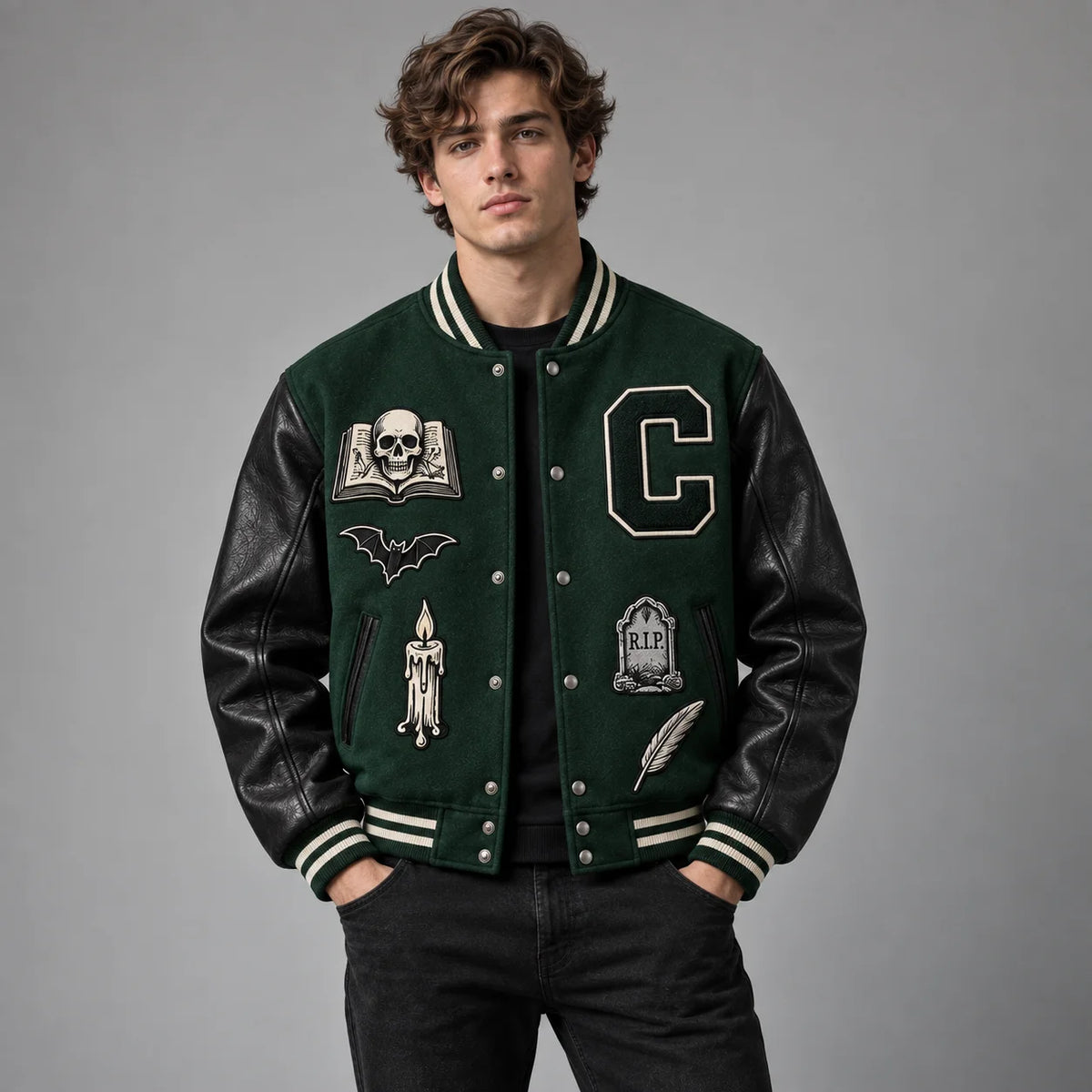 Front studio view of Crypt Academy forest green varsity jacket with skull, bat, candle and tombstone patches