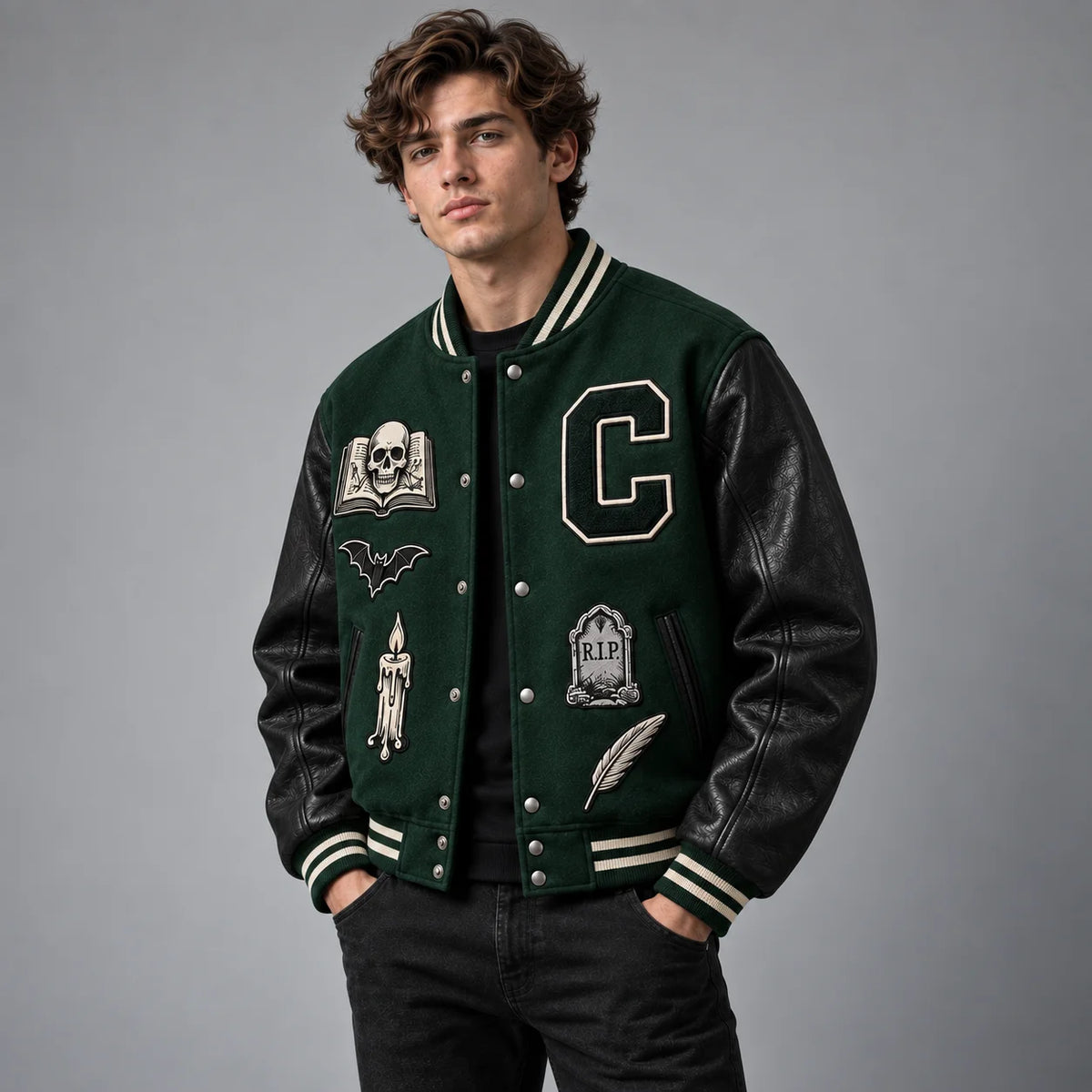 Three-quarter view of green and black gothic Halloween varsity jacket with embroidered front patches