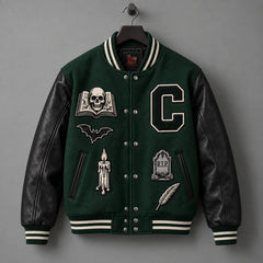 Front hanger view of forest green varsity jacket with genuine black leather sleeves and gothic embroidery
