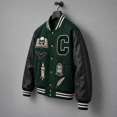 Angled product view of green Halloween letterman jacket with black leather sleeves and striped rib knit