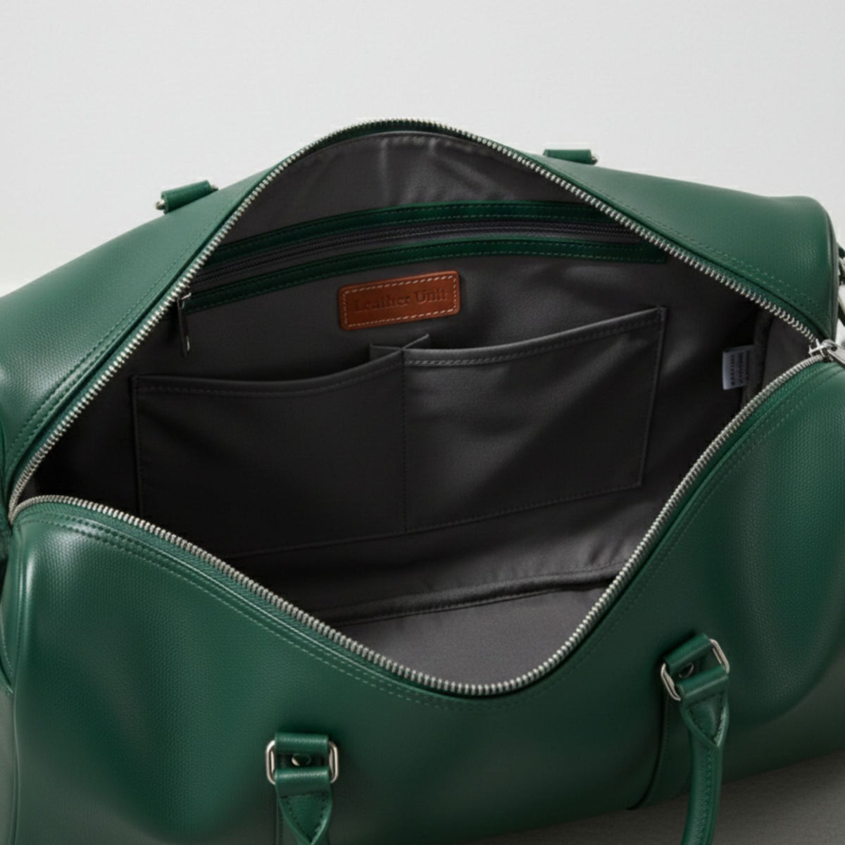 interior of green leather duffle bag with grey lining zip pocket and slip pockets.