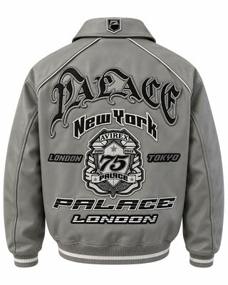 Full back view of grey leather bomber jacket with large graphic emblem, contrast piping and striped ribbed waistband