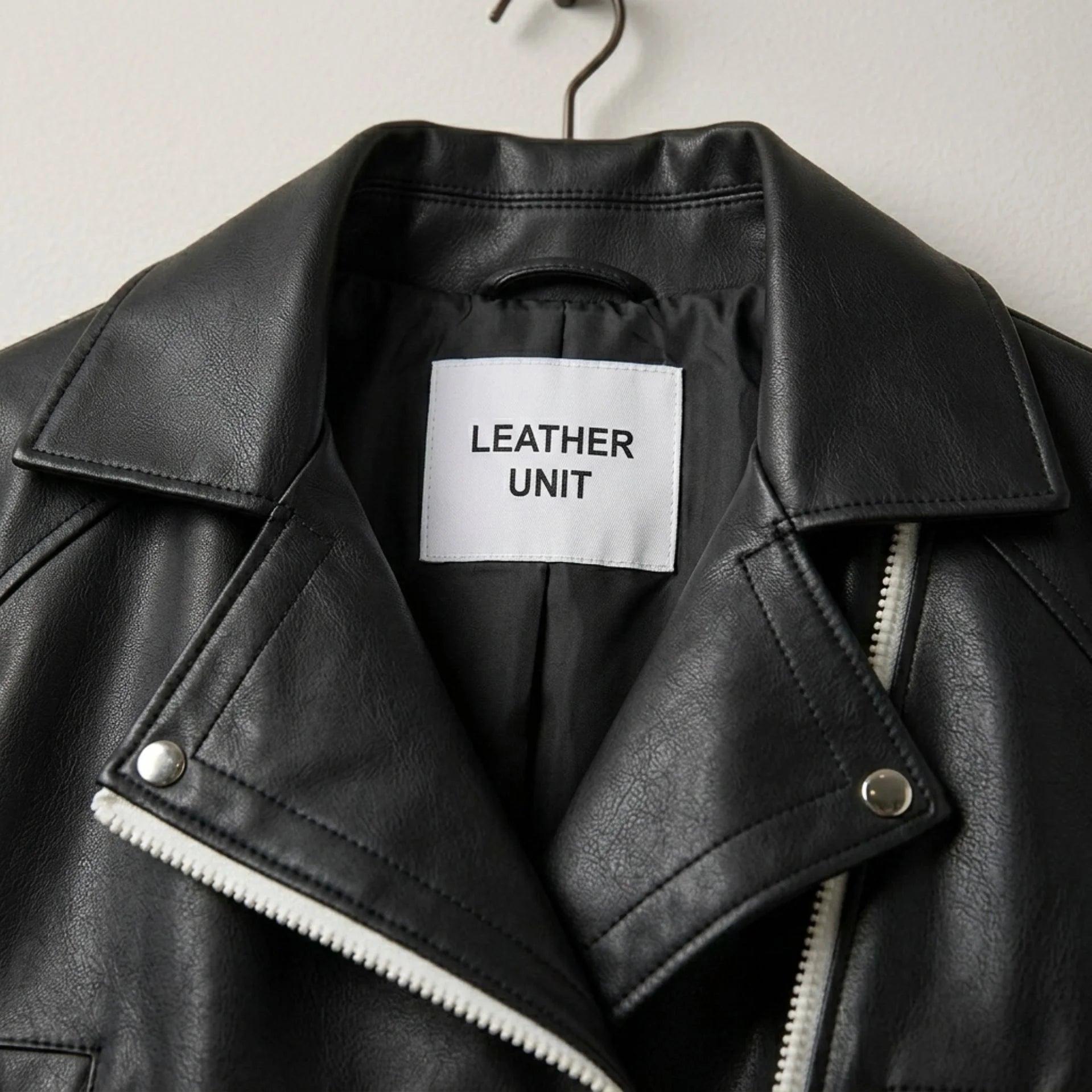 Close-up of lapel collar and label on Leather Unit black leather biker jacket