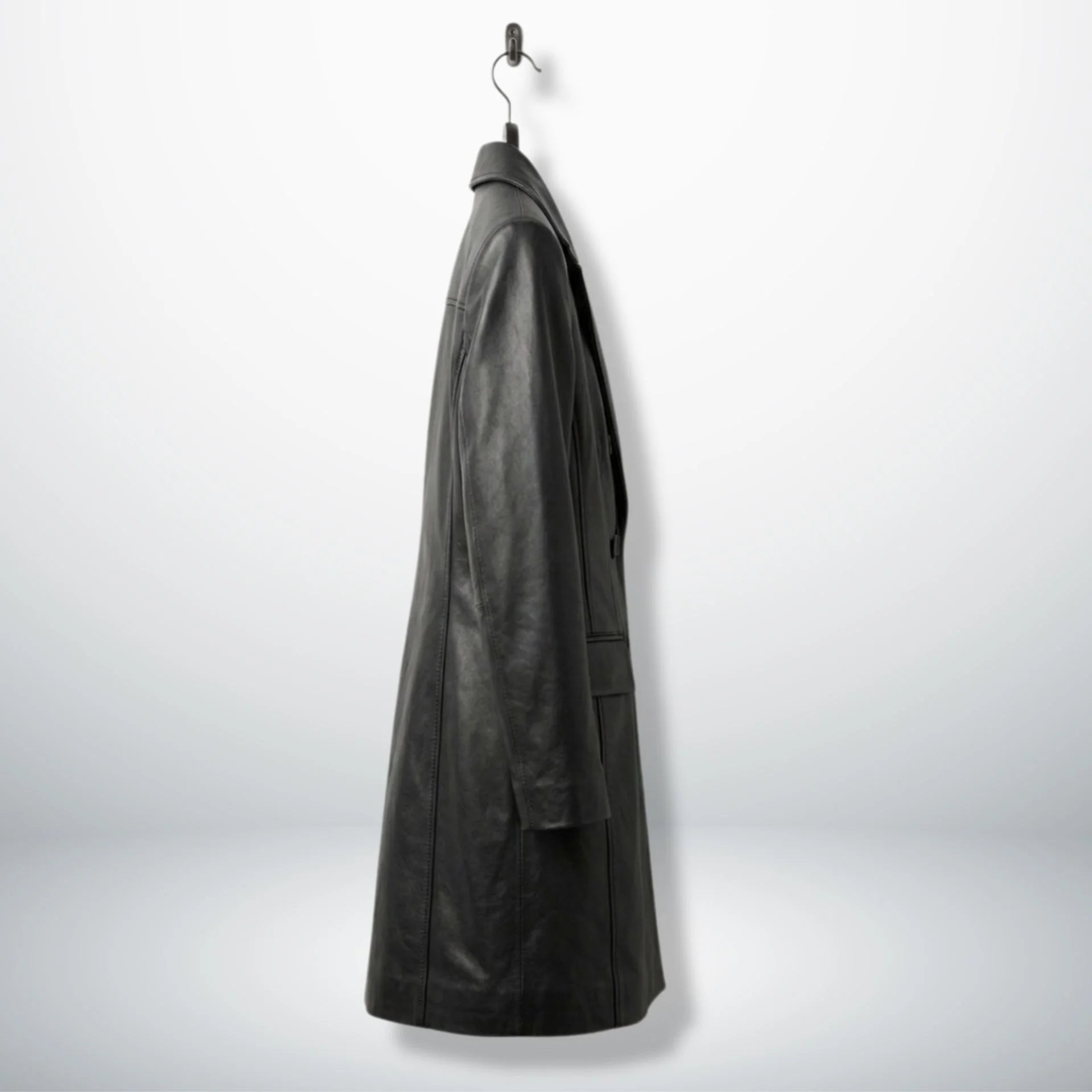 Side profile of long black leather coat for women