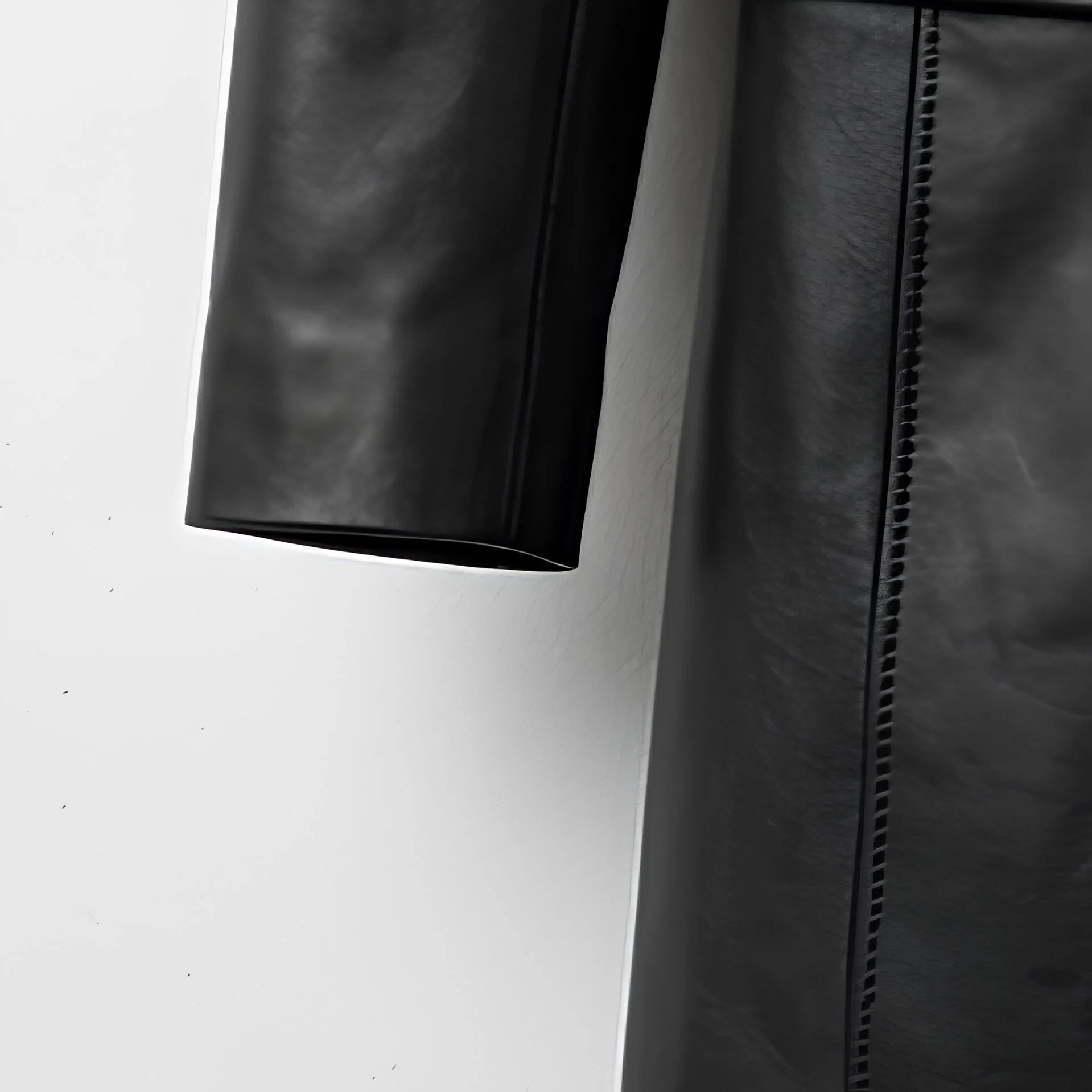 Sleeve and side seam detail on women’s black leather coat