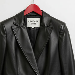 Close up of notched lapels and Leather Unit label on black leather blazer