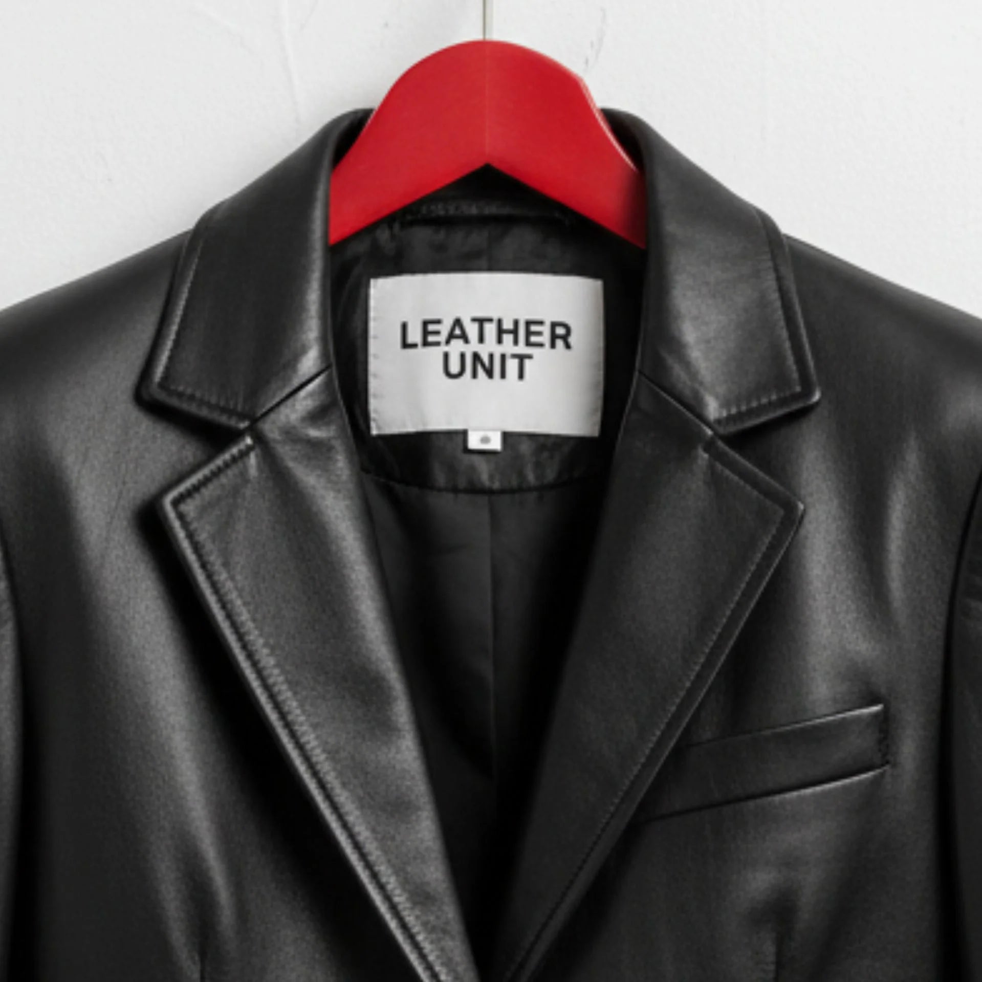Close up of lapel collar and Leather Unit label on black leather blazer