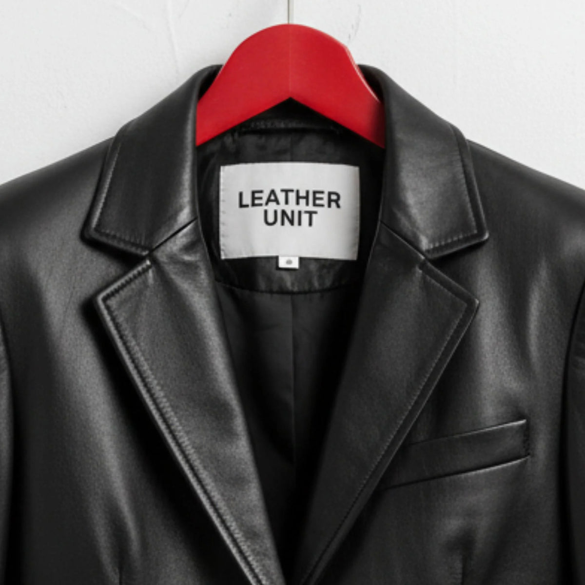 Close up of lapel collar and Leather Unit label on black leather blazer