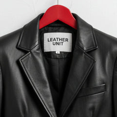 Close up of lapel collar and Leather Unit label on black leather blazer