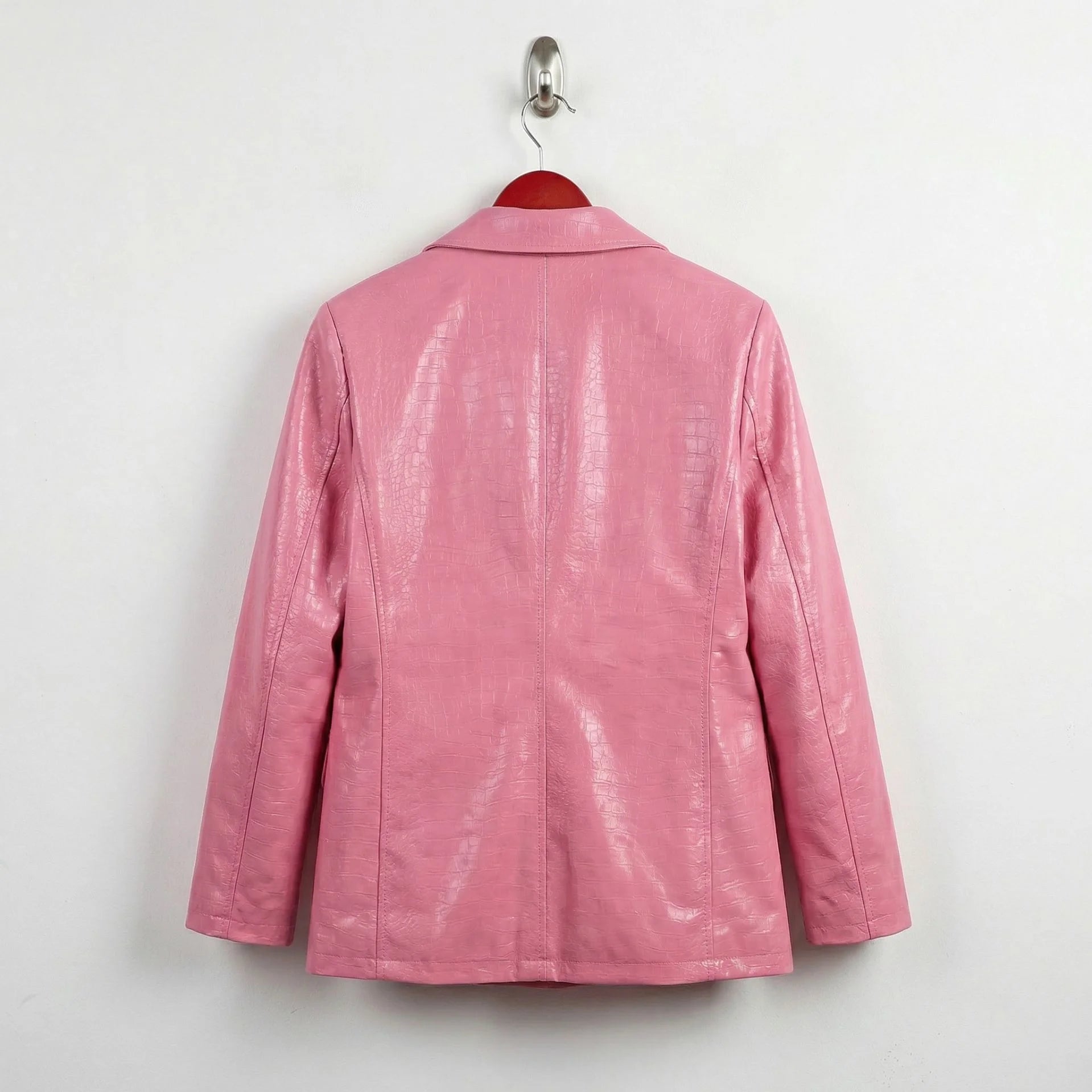 Back view of women’s blush pink crocodile embossed leather blazer