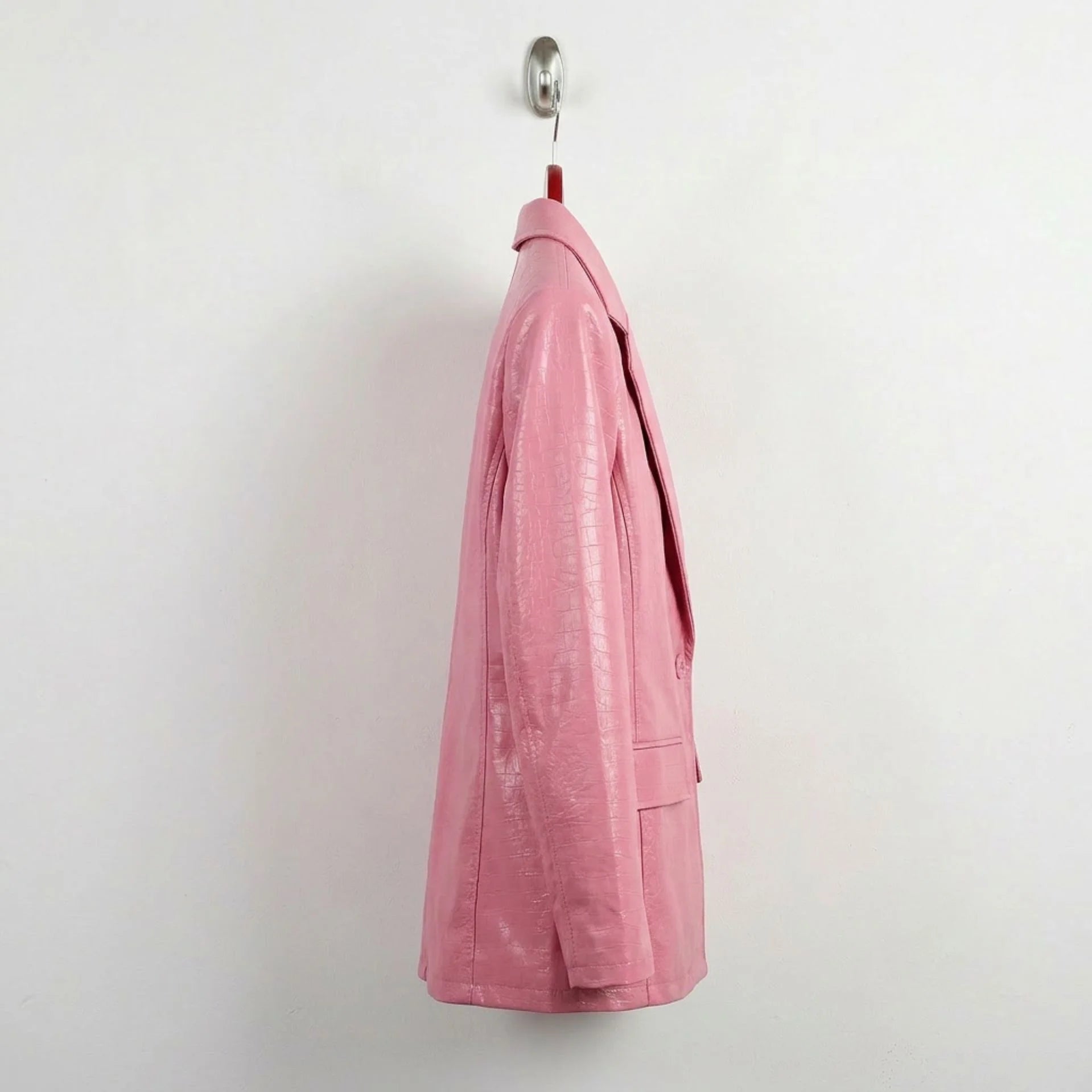 Side profile of women’s blush pink leather blazer hip length