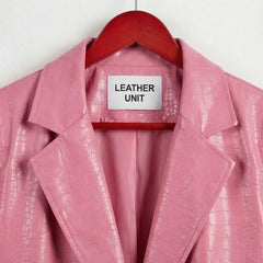 Close up of notched lapels and Leather Unit label on pink leather blazer