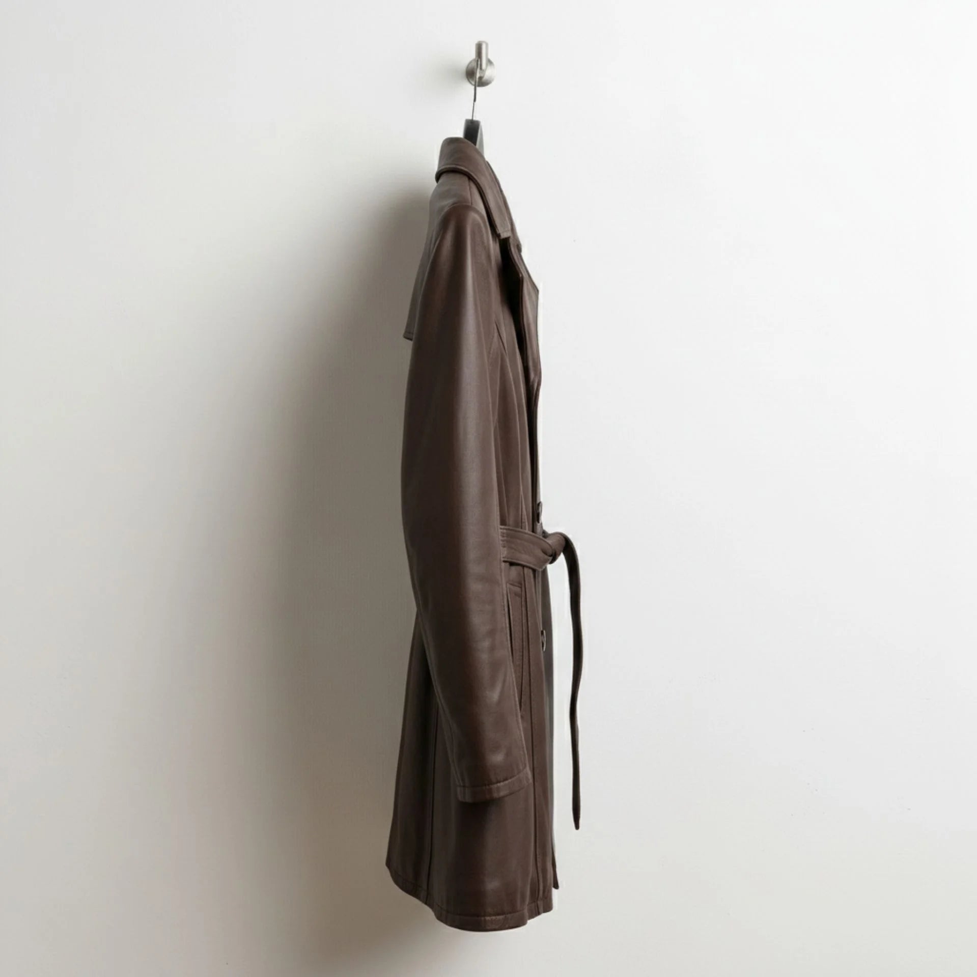 Side profile of mid length brown leather coat for women