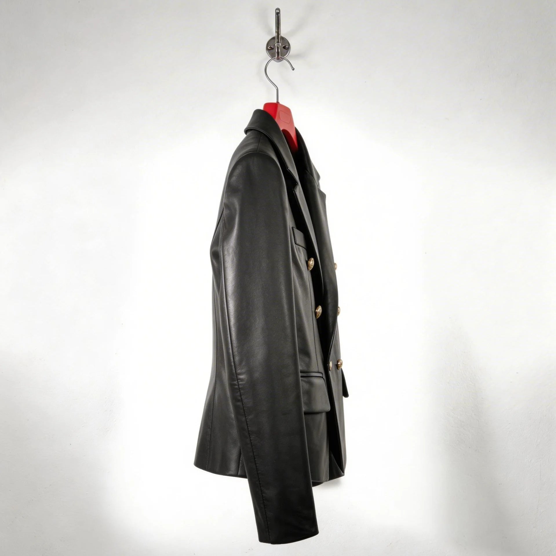 Side profile of structured double breasted black leather blazer for women